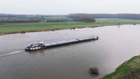 Orbit-shot-moving-away-from-the-ship-sailing-over-the-IJssel-with-high-water