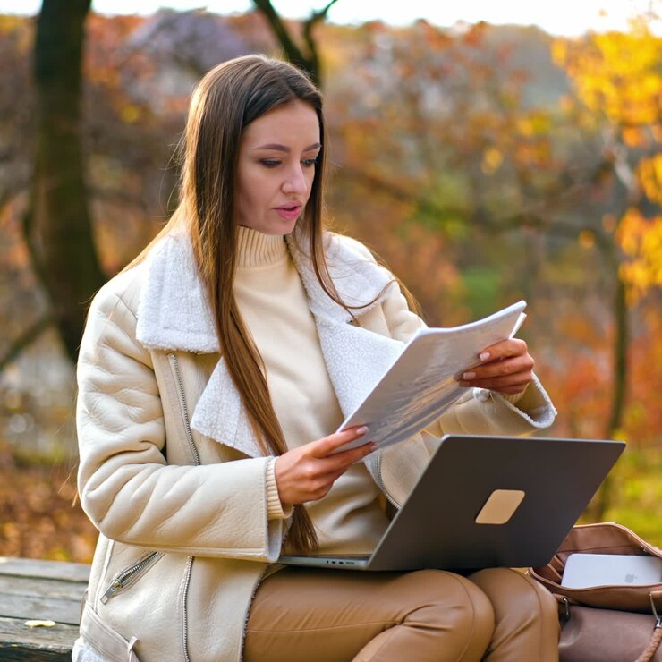 Young attractive woman working in park with laptop. Freelance charming lady have distance work