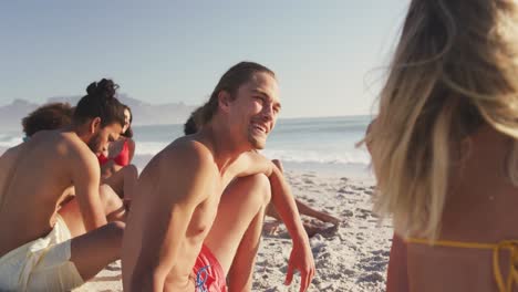 friends talking and laughing at beach