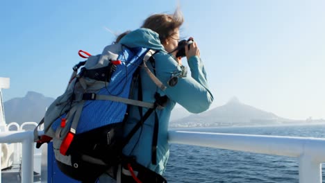 Woman-clicking-photo-with-camera-while-travelling-in-ferry-4k