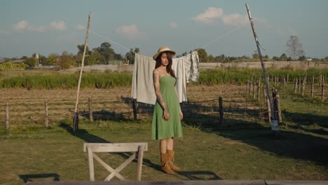 woman in a green dress in a rural setting