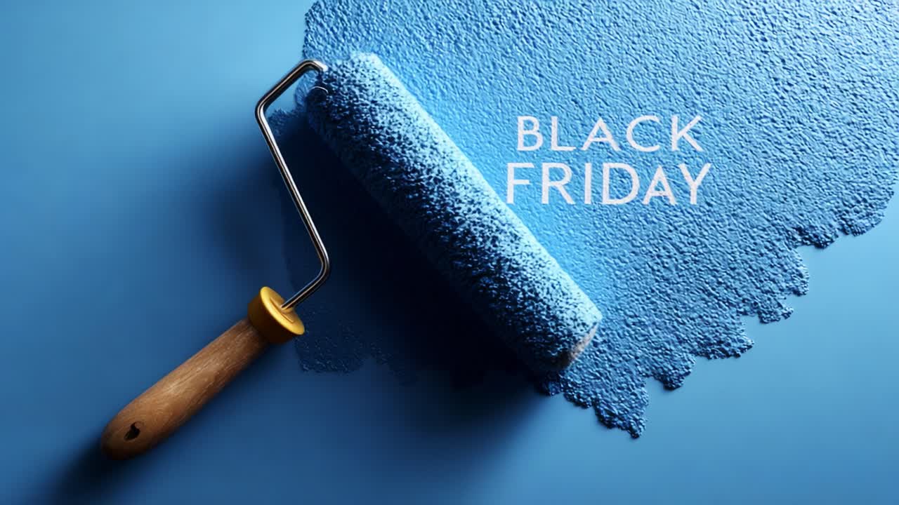 A vibrant blue paint roller resting on a smooth blue surface, revealing the text 'Black Friday', showcasing a creative and promotional concept linked to seasonal sales and deals