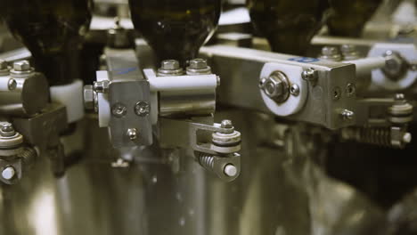 close up of industrial bottle washing machine in operation