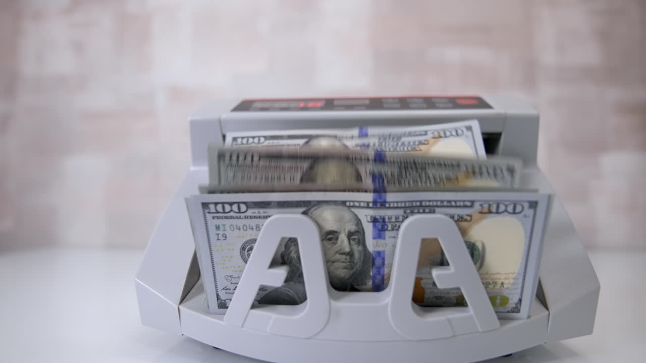 Money counting machine. Counting dollar banknotes.