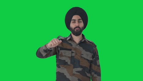 disappointed sikh indian army man showing thumbs down green screen