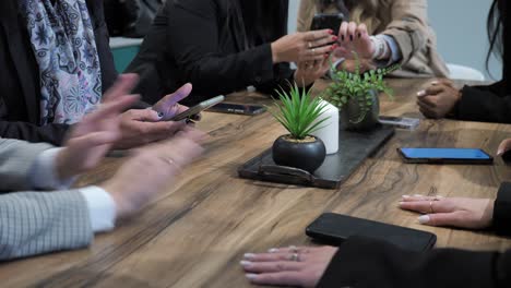 close up on employees hand gesticulate over table in conference room