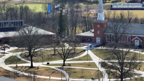 long aerial zoom of walking paths and chapel on christian university in america