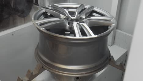 the aluminium wheel is finished cutting to repair a curb rash, is lifted out of the cabinet in 4k