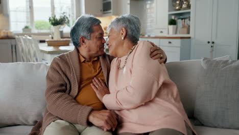 Happy,-senior-couple-and-a-kiss-on-the-sofa
