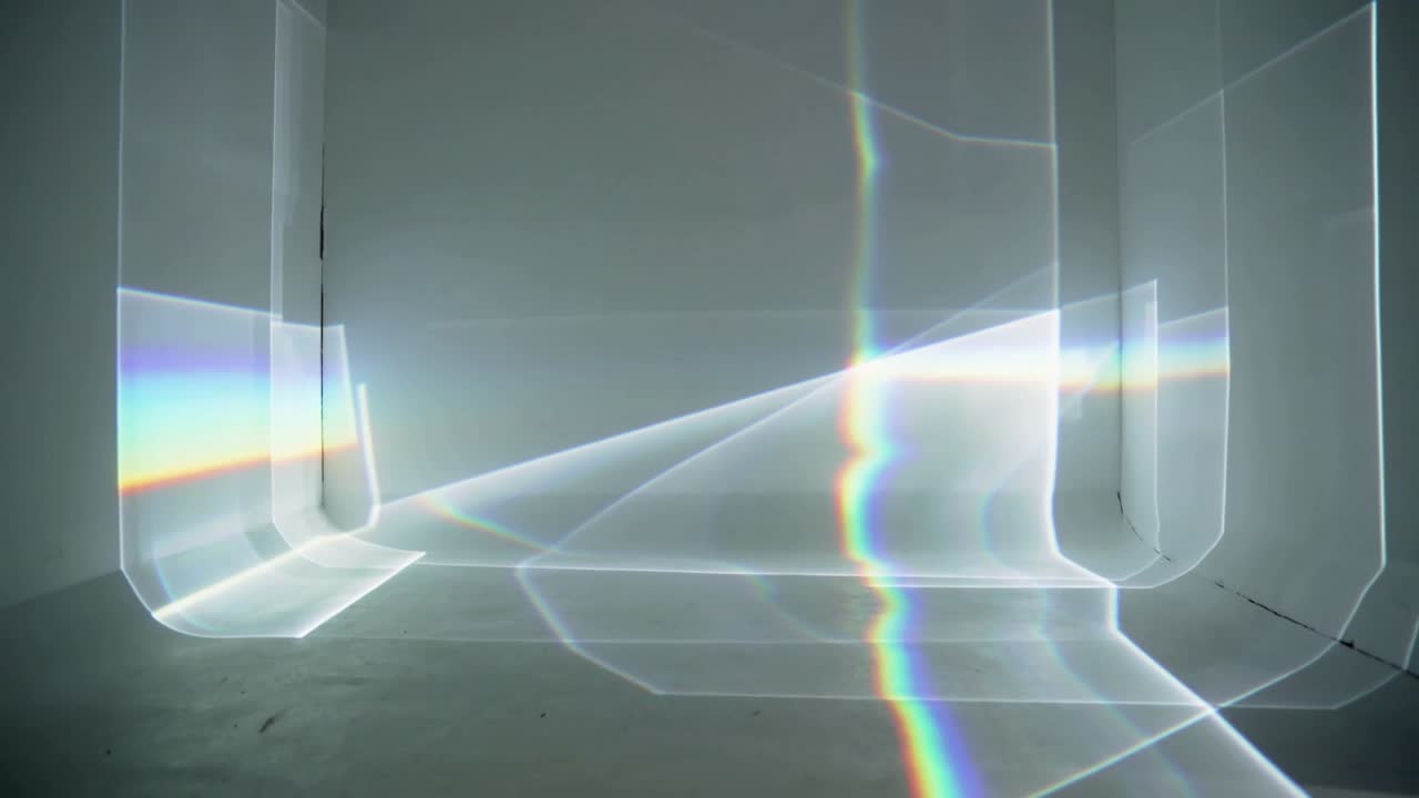 Shifting refracted light moving across gallery, projector casting vertical spectrum for display