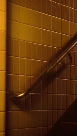 golden staircase with metal railing