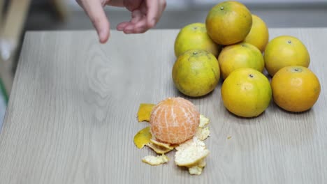 sequential frames showing the peeling of an orange