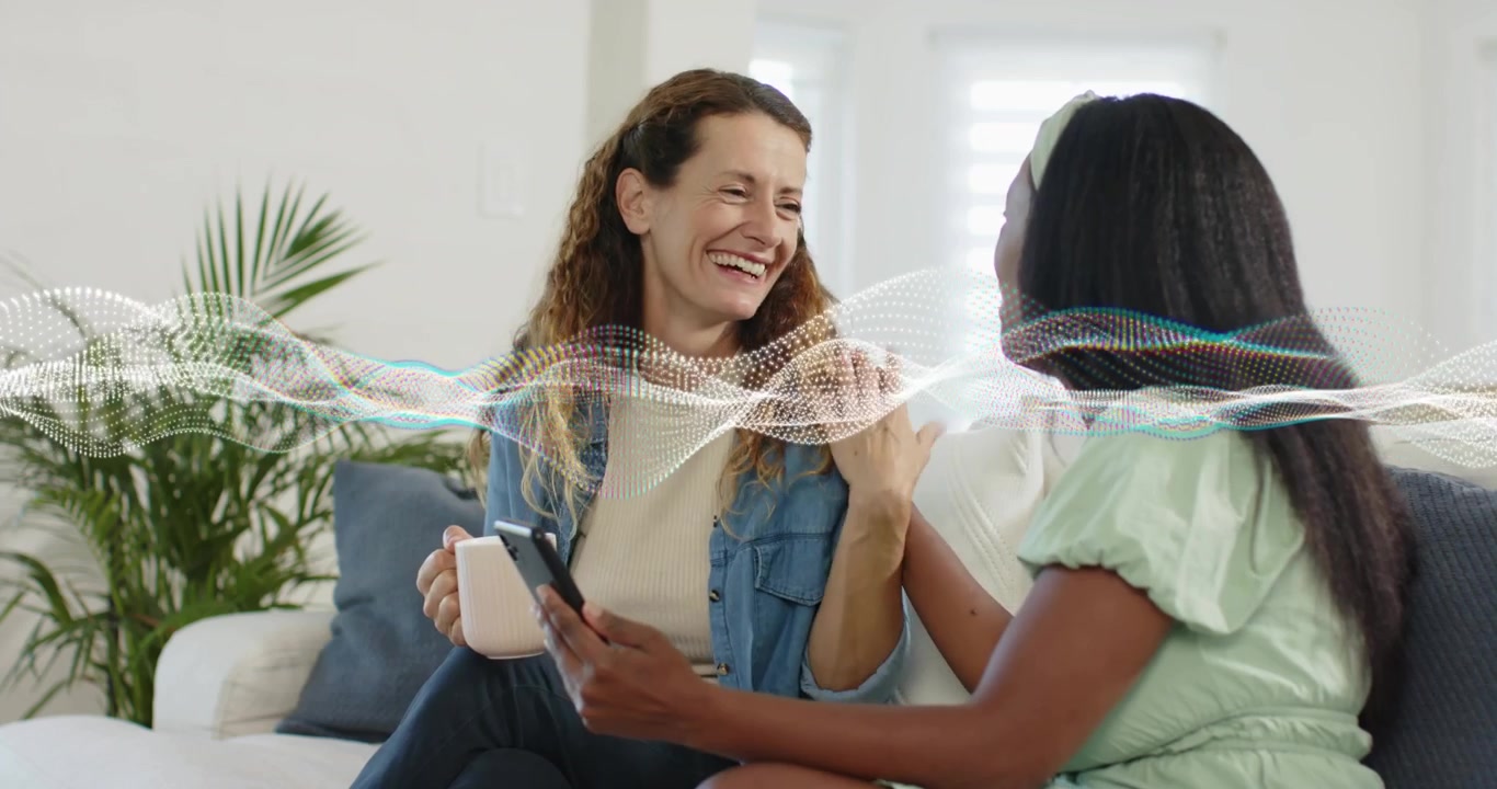 Two friends tapping smartphone while reviewing technology, laughing with audio waveform moving