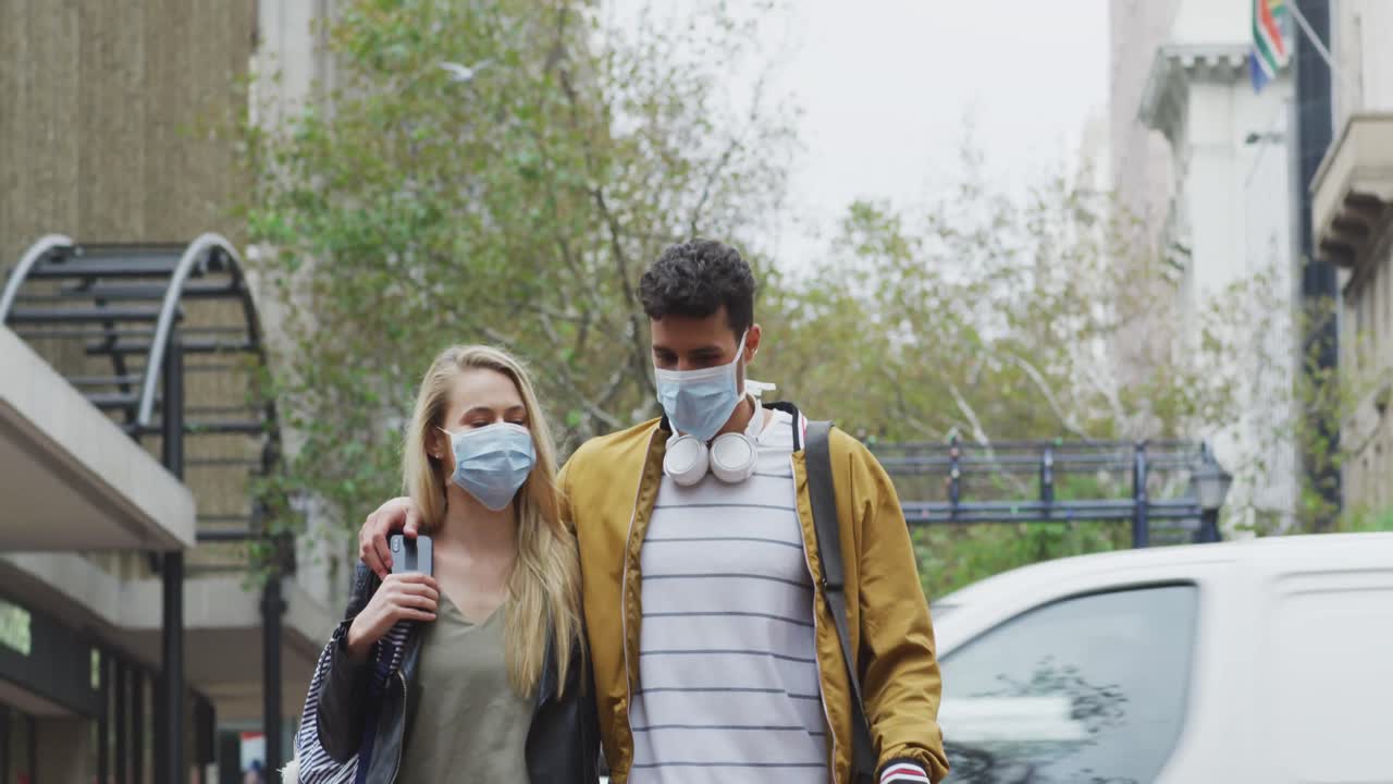 Front view of Caucasian couple on the go wearing coronavirus Covid19 mask