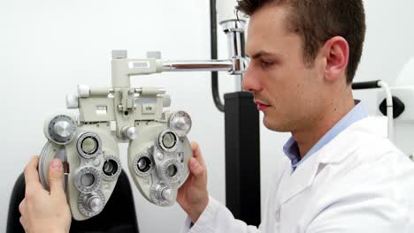 smiling optometrist adjusting chiropter