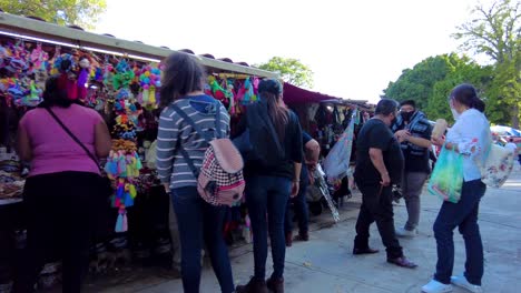 local craftsman shops at the downtown city square with tourist wearing masks during the pandemic. happy family leisure moments. latin-america