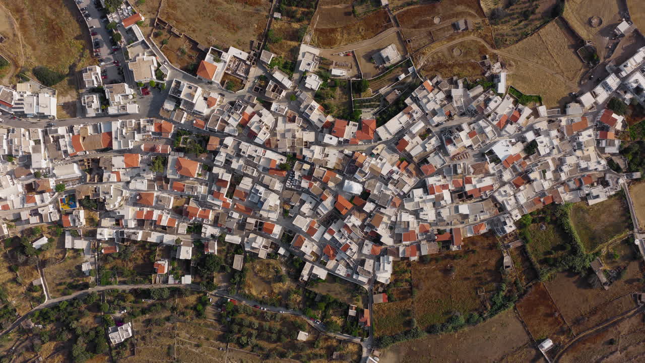 Overhead aerial of Kythnos Chora village on Kythnos island during sunrise, Cyclades, establishing shot