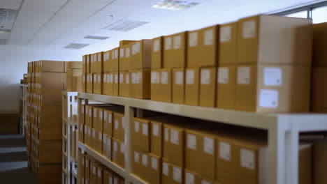 rows of cardboard boxes on shelves in a warehouse