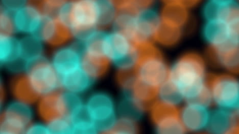 Blurry abstract composition featuring small circles in shades of blue, orange, and brown, creating a vibrant and dynamic visual pattern