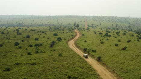 on an adventure in africa in safari vehicle through vast savannah