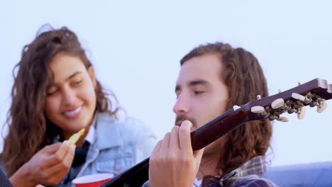 couple having fun on car bonnet 4k