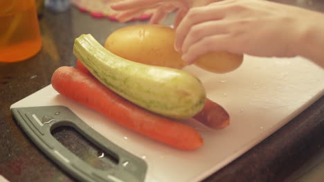 female hands putting vegetables and ingredients on cutting board