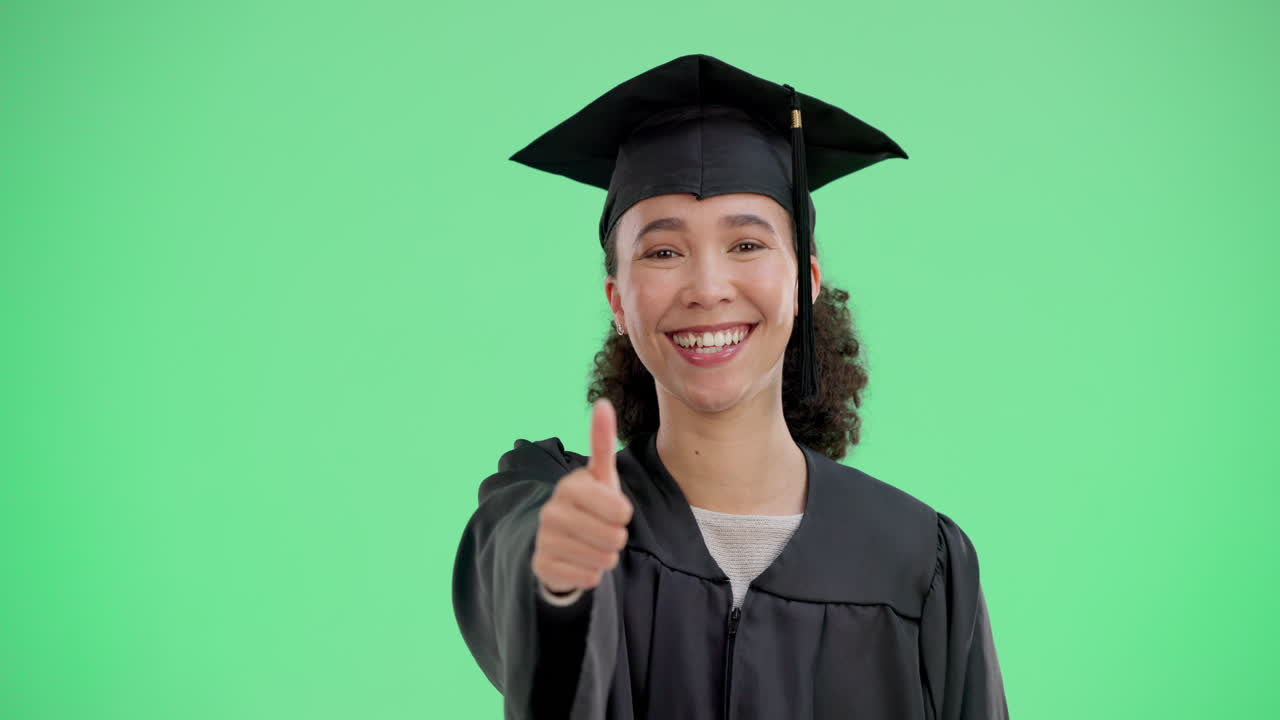 A happy graduate giving a thumbs up