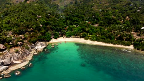 slowly pulling in on an aerial drone shot of the beachfront of haad tian beach located in koh tao island in surat thani province, thailand