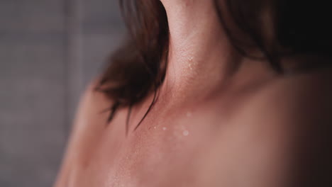 woman with acne on neck takes shower in bathroom closeup. lady with problematic skin stands in washroom. skincare hygienic routine and treatment