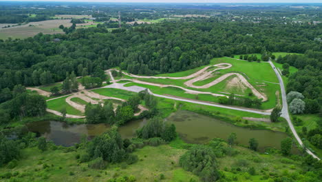 aerial view of a green landscape with a river and hiking trails