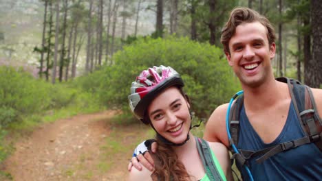 happy couple taking a break while biking