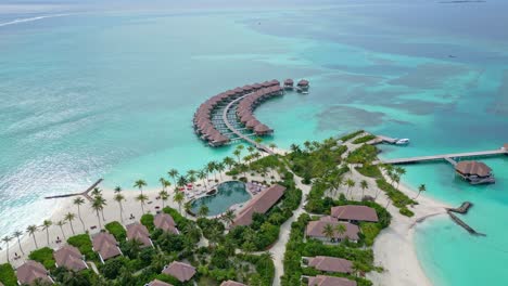 aerial view over holiday bungalows at a vacation resort, sunny day in maldives