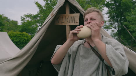 viking reenactment: man drinking from a cup