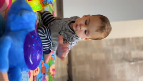 baby playing with toys on playmat