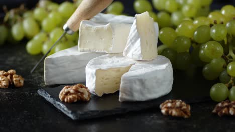 camembert cheese with grapes and walnuts rotates slowly.