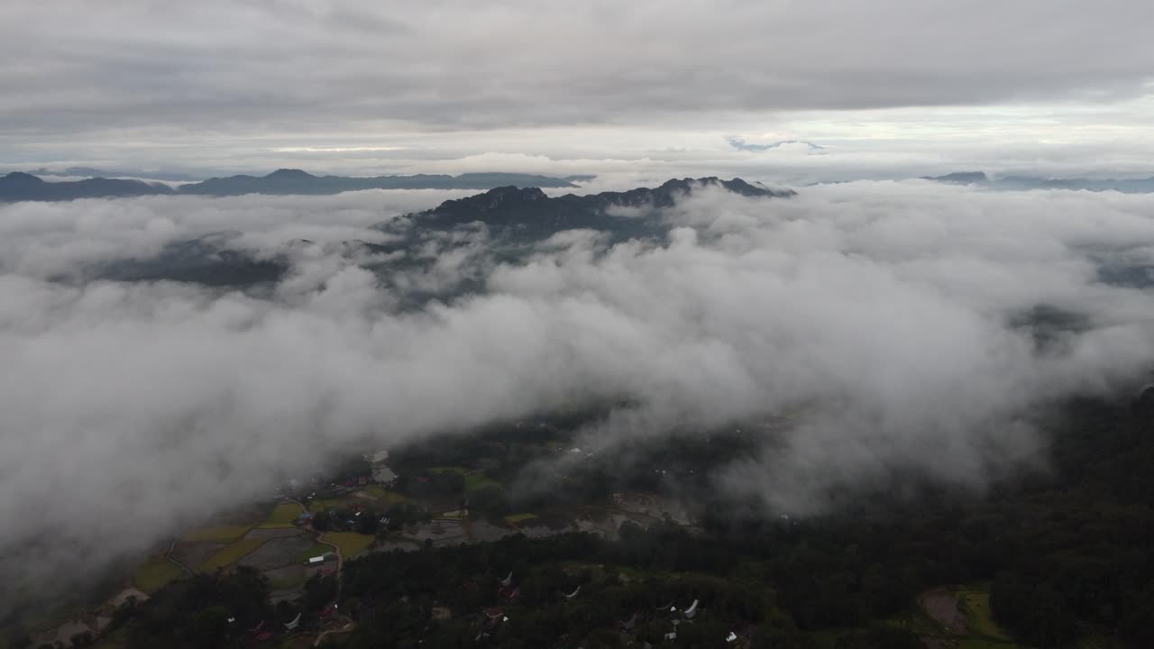 Aerial View of Mountains and Village Covered by Clouds