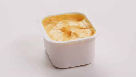 cheese sauce in plastic container