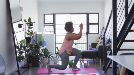 african american female plus size standing on exercise mat working out