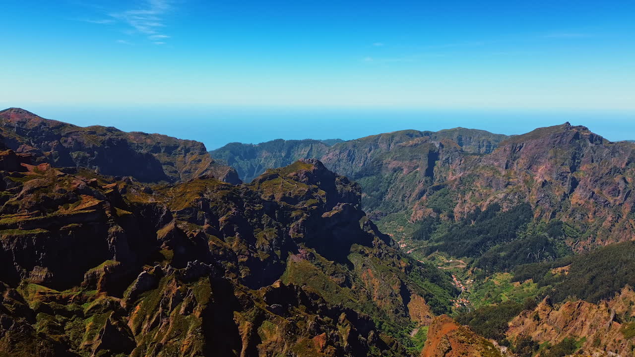 Sunny view of high dangerous rocks at the backdrop of blue sky. Stunning landscape of the Madeira Islands, Portugal.