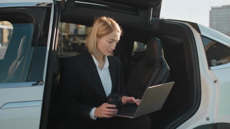 businesswoman working in electric car