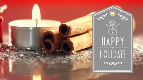 happy holidays text with gift, lit candles and cinnamon sticks 4k