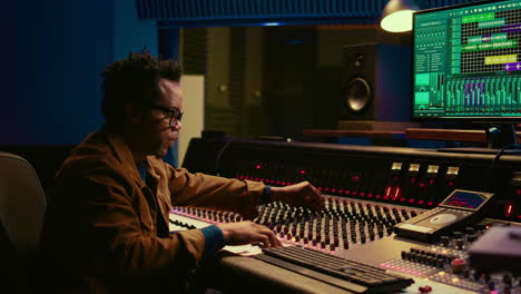 portrait of african american sound designer mixing and mastering tracks