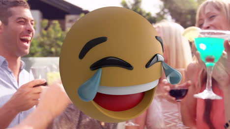laughing emoji animation over group of friends enjoying drinks outdoors