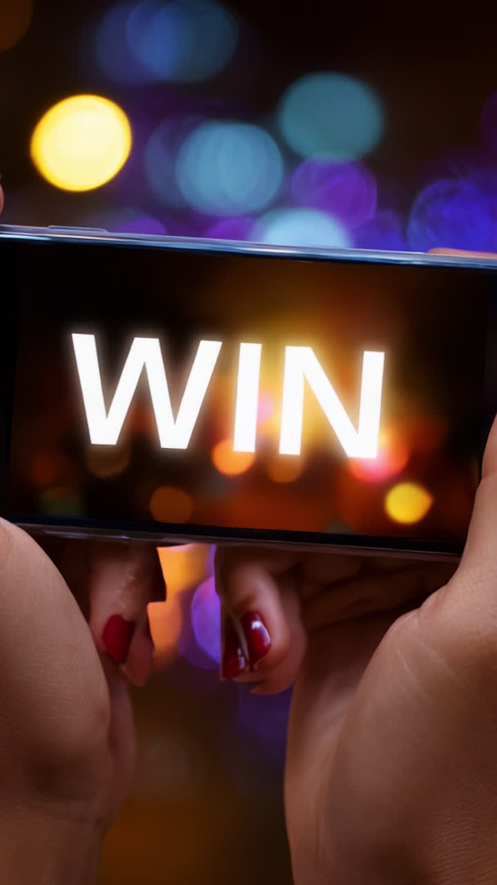 A Dynamic Capture of a Smartphone Displaying the Word 'WIN' Against a Colorful Background, Symbolizing Victory and Celebration