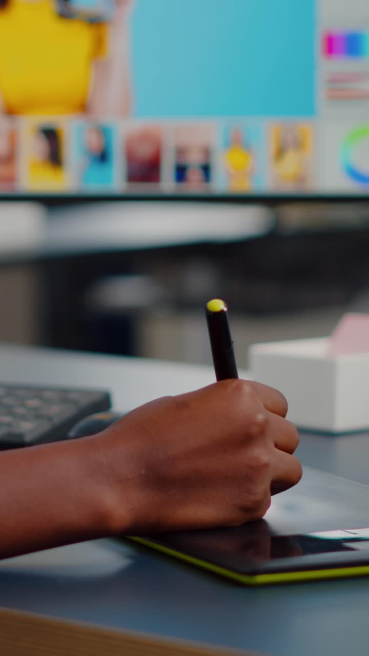 Vertical video Close up of african photo retoucher holding stylus pen editing customer photo