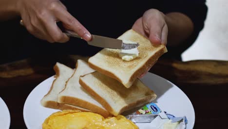 sequential buttering of toast on a plate