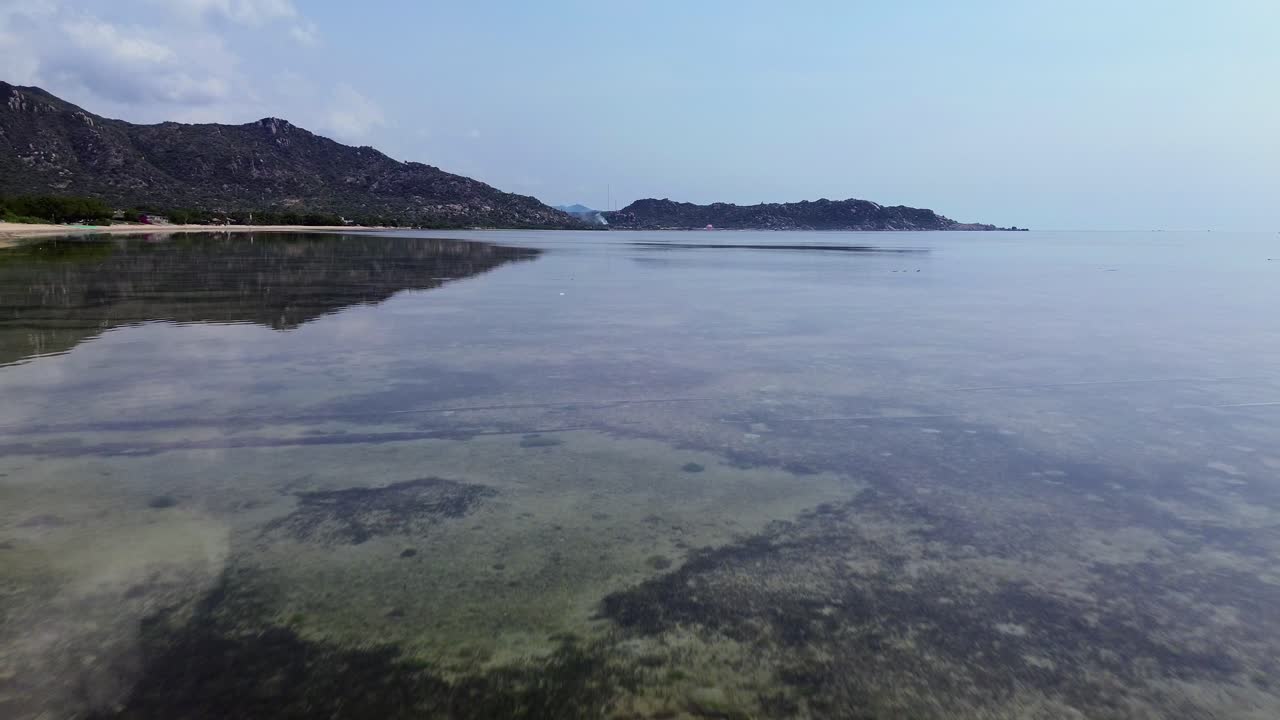 Drone aerial over My Hoa Town showing colorful rooftops and the tranquil lagoon, capturing vibrant tropical townscape in Vietnam