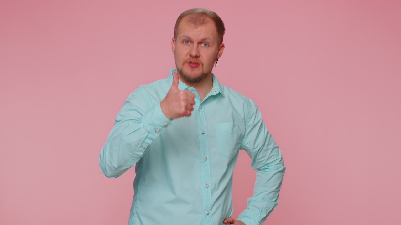 Tourist stylish man in shirt showing thumbs up and nodding in approval successful good work