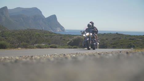 motorcycle passing in slow motion in the middle of a south african road landscape