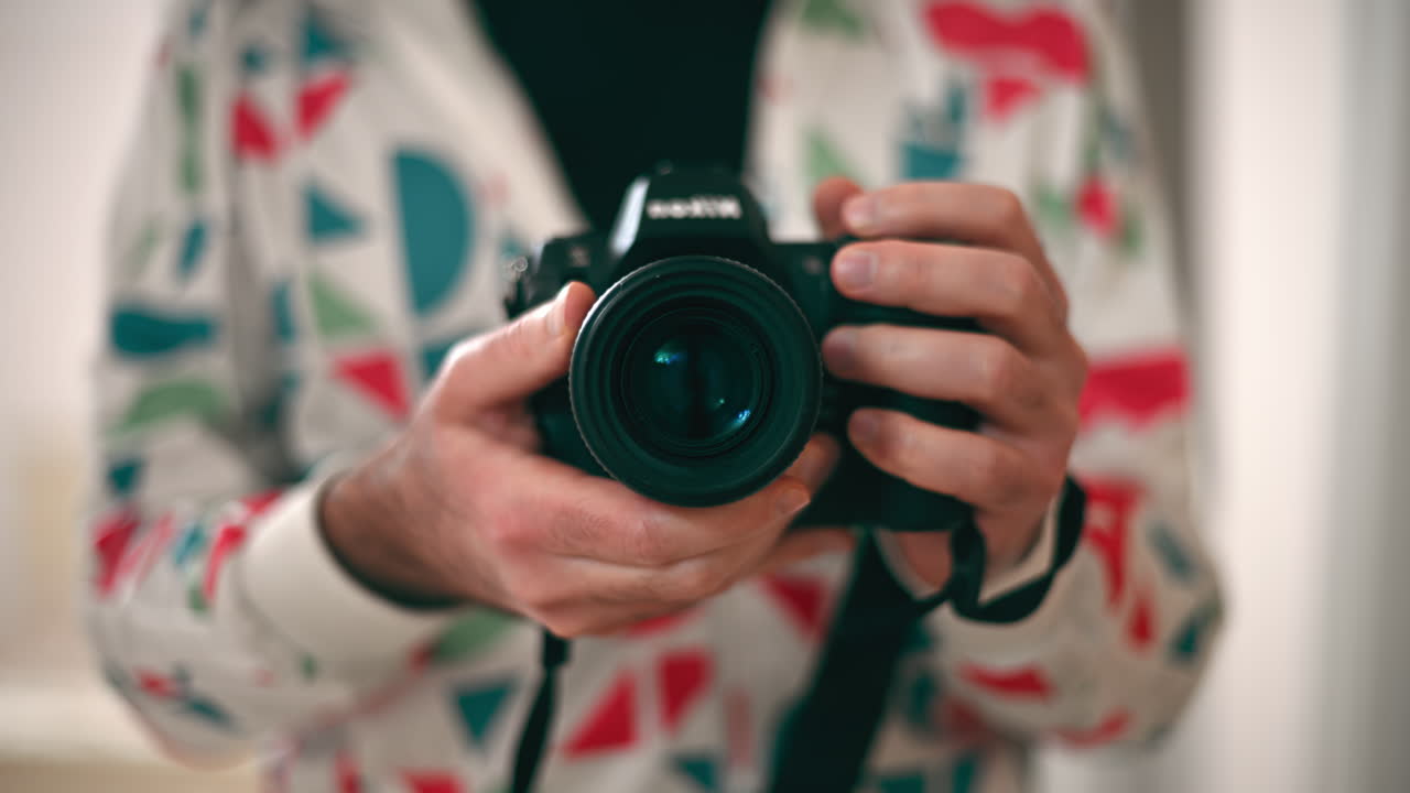 Man holding a camera shooting in the mirror